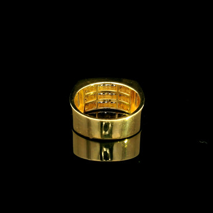 Men’s diamond statement ring in 18K yellow gold featuring three rows of round brilliant diamonds across a wide tapered gold band.