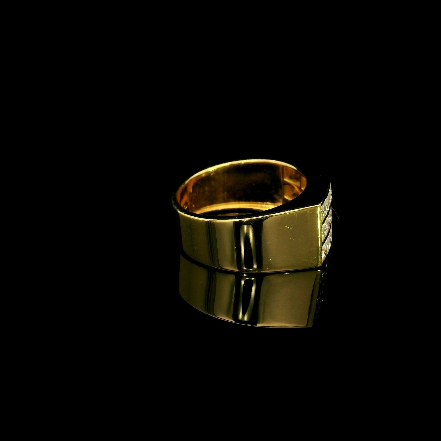 Men’s diamond statement ring in 18K yellow gold featuring three rows of round brilliant diamonds across a wide tapered gold band.