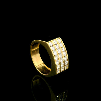 Men’s diamond statement ring in 18K yellow gold featuring three rows of round brilliant diamonds across a wide tapered gold band.