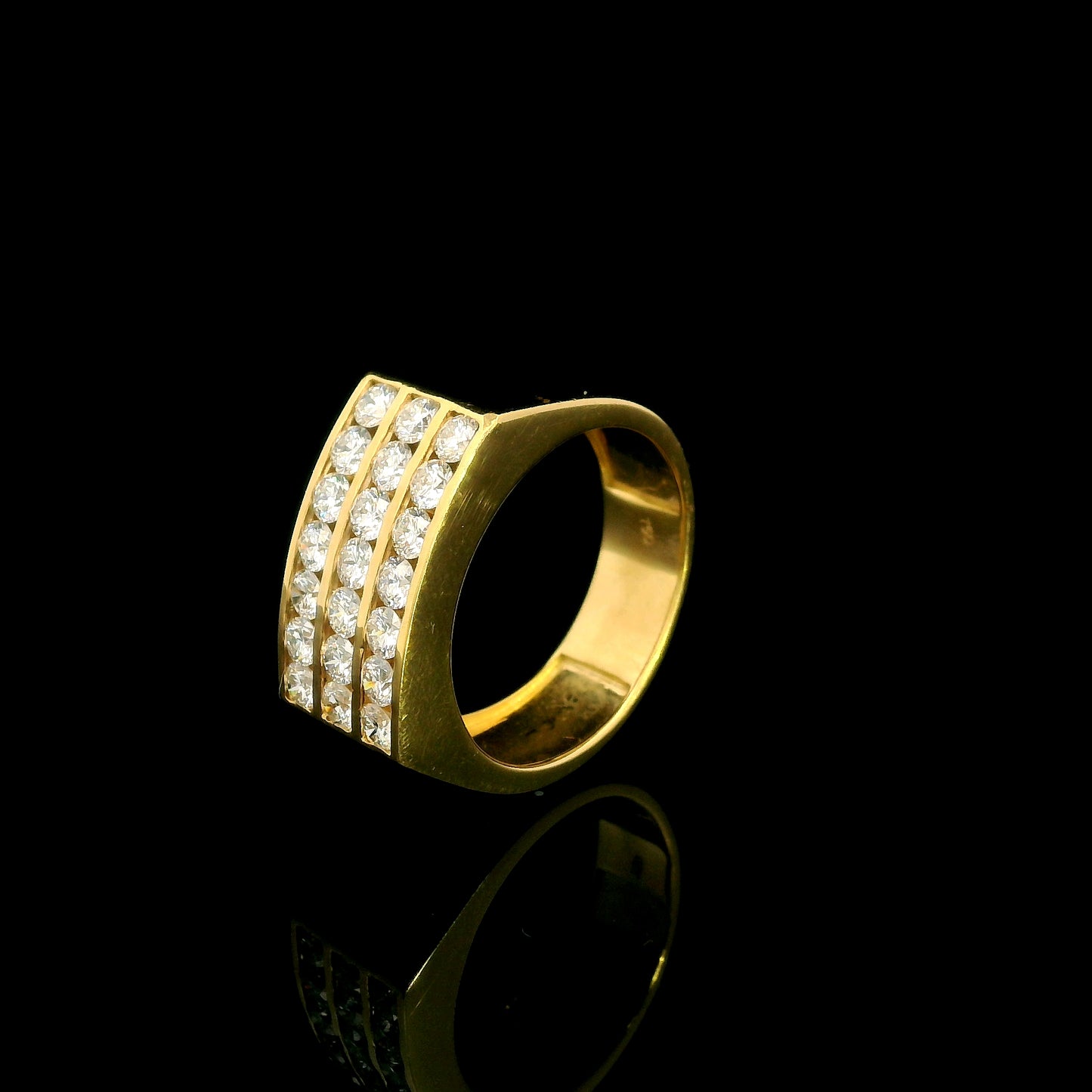 Men’s diamond statement ring in 18K yellow gold featuring three rows of round brilliant diamonds across a wide tapered gold band.