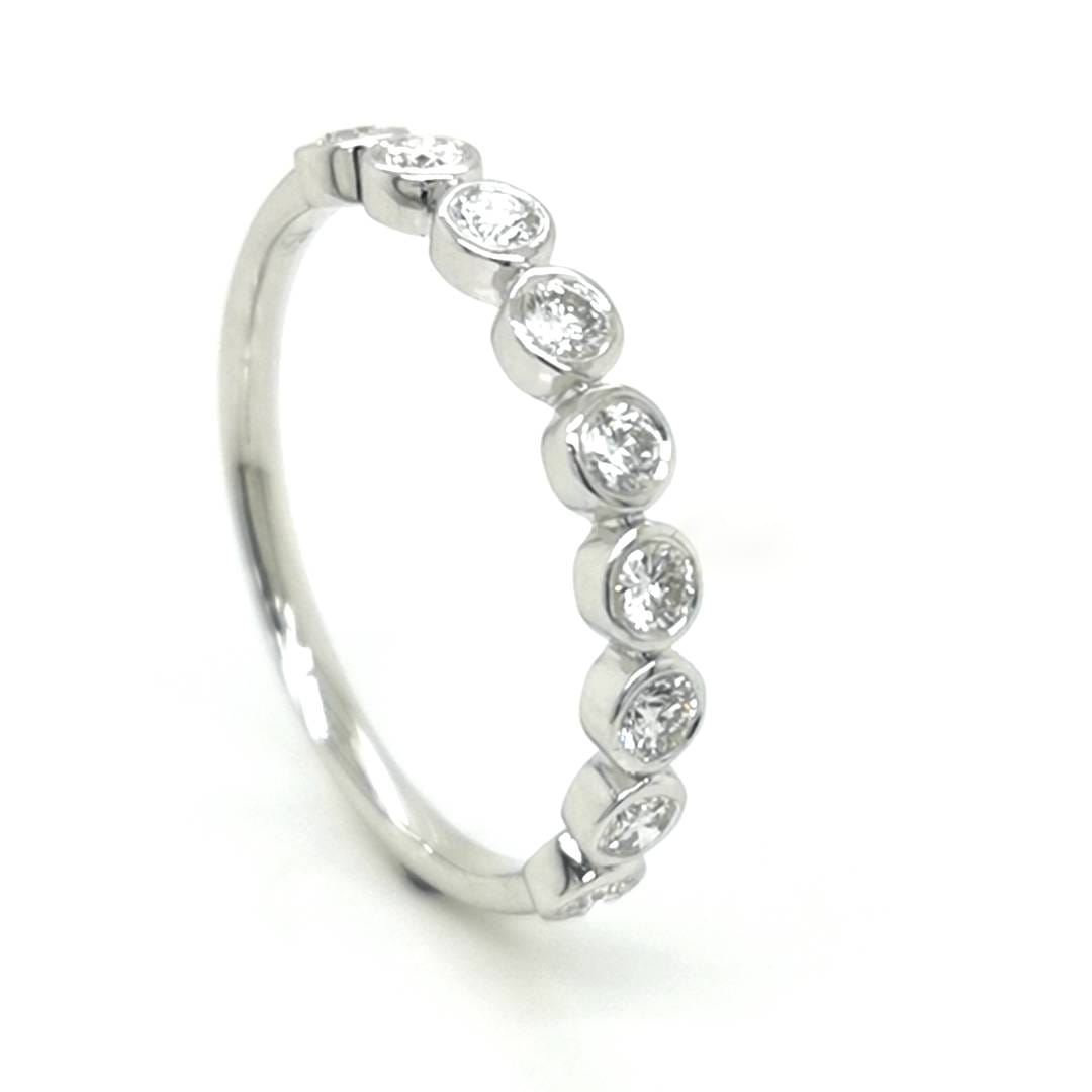 Bezel Set Half Eternity Diamond Ring In 18k White Gold.