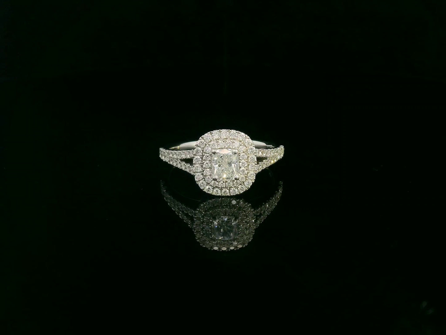 Cushion cut diamond halo engagement ring in 18K white gold with pavé diamond band by Emirates Diamonds