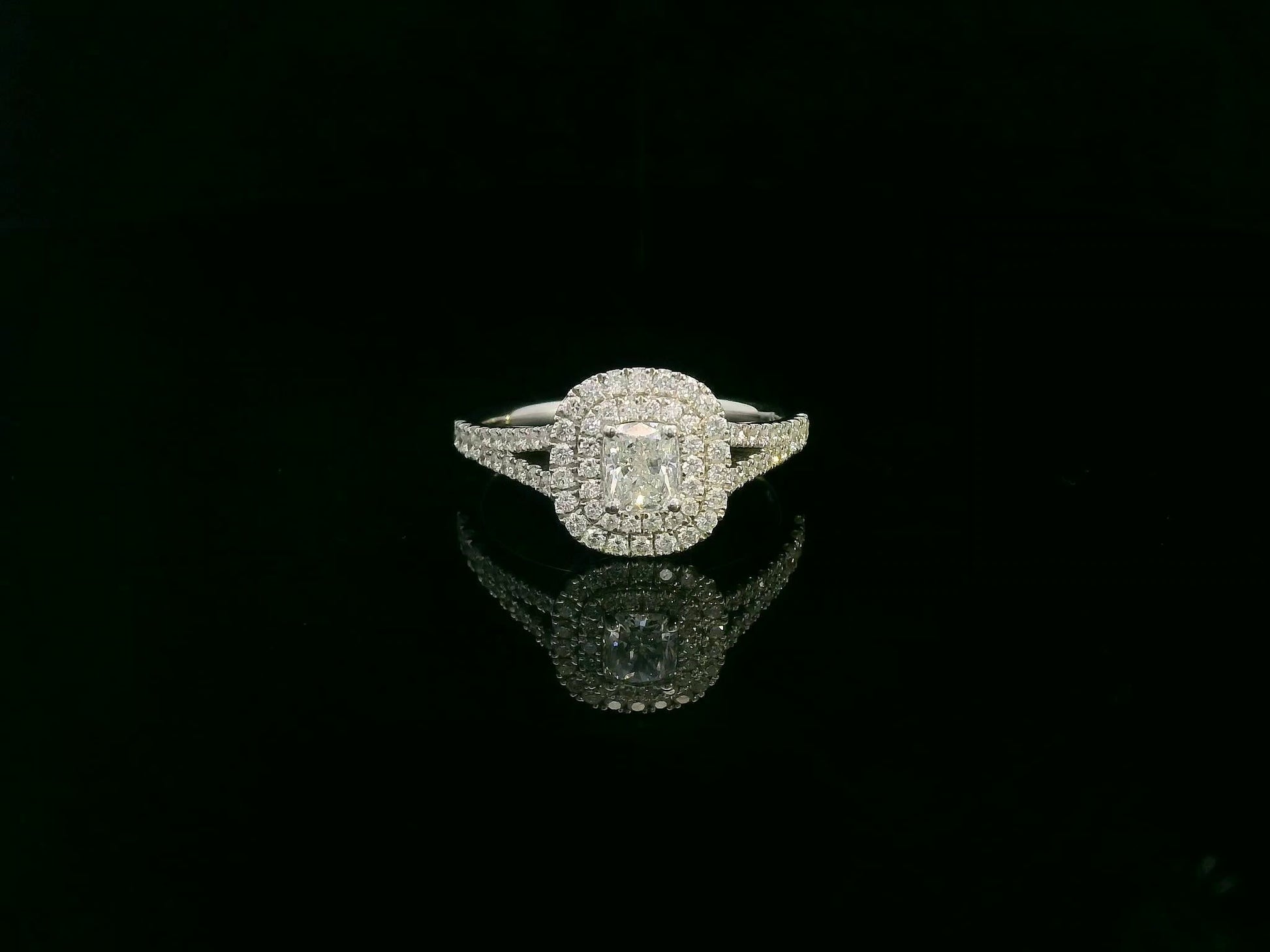 Cushion cut diamond halo engagement ring in 18K white gold with pavé diamond band by Emirates Diamonds