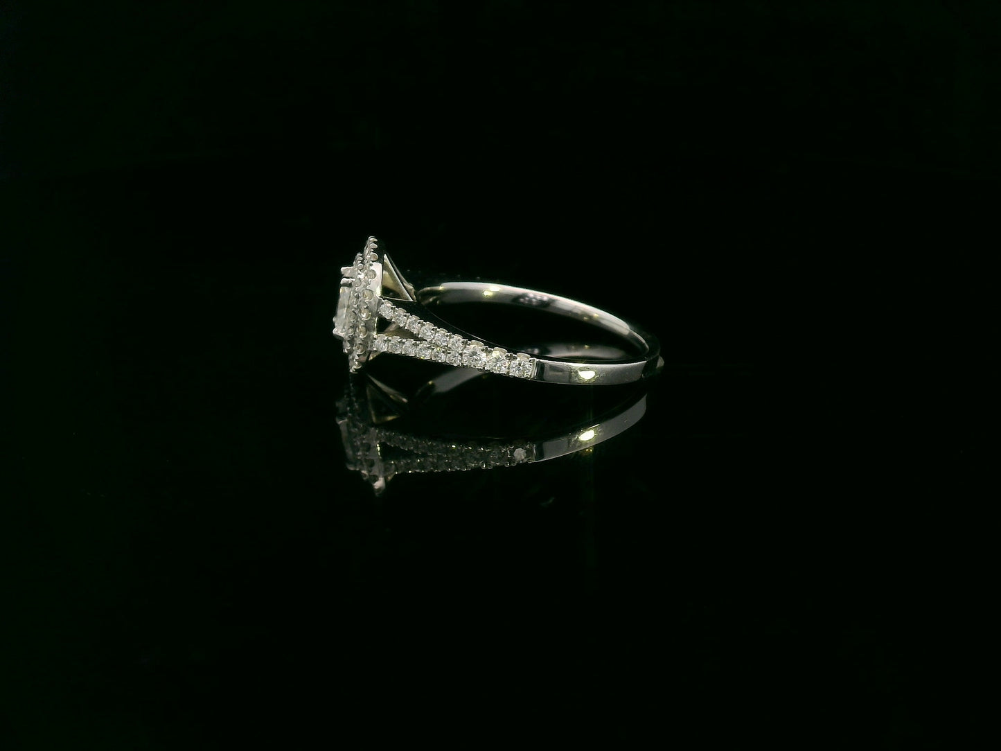 Cushion cut diamond halo engagement ring in 18K white gold with pavé diamond band by Emirates Diamonds