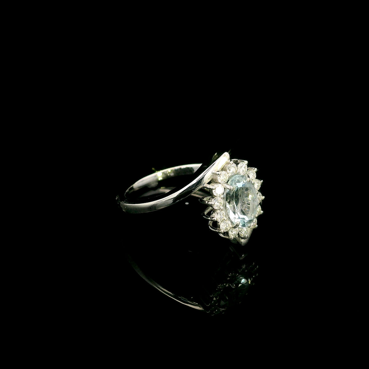 Oval aquamarine diamond halo ring with sweeping 18K white gold band