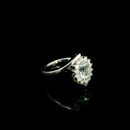 Oval aquamarine diamond halo ring with sweeping 18K white gold band