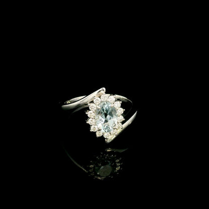 Oval aquamarine diamond halo ring with sweeping 18K white gold band