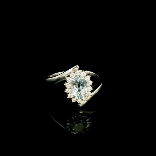 Oval aquamarine diamond halo ring with sweeping 18K white gold band