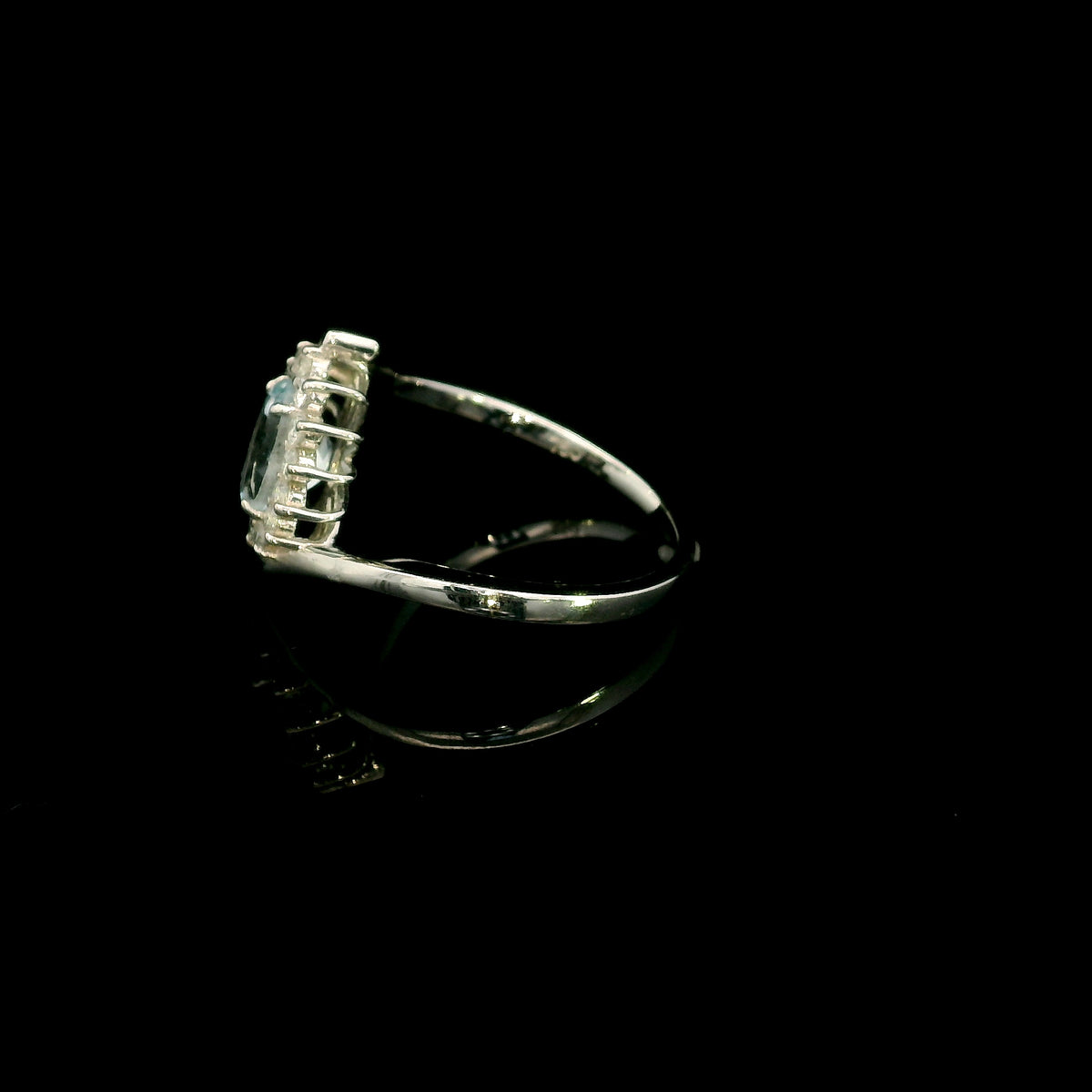 Oval aquamarine diamond halo ring with sweeping 18K white gold band