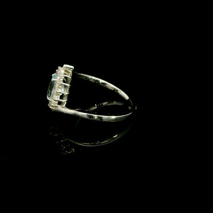 Oval aquamarine diamond halo ring with sweeping 18K white gold band