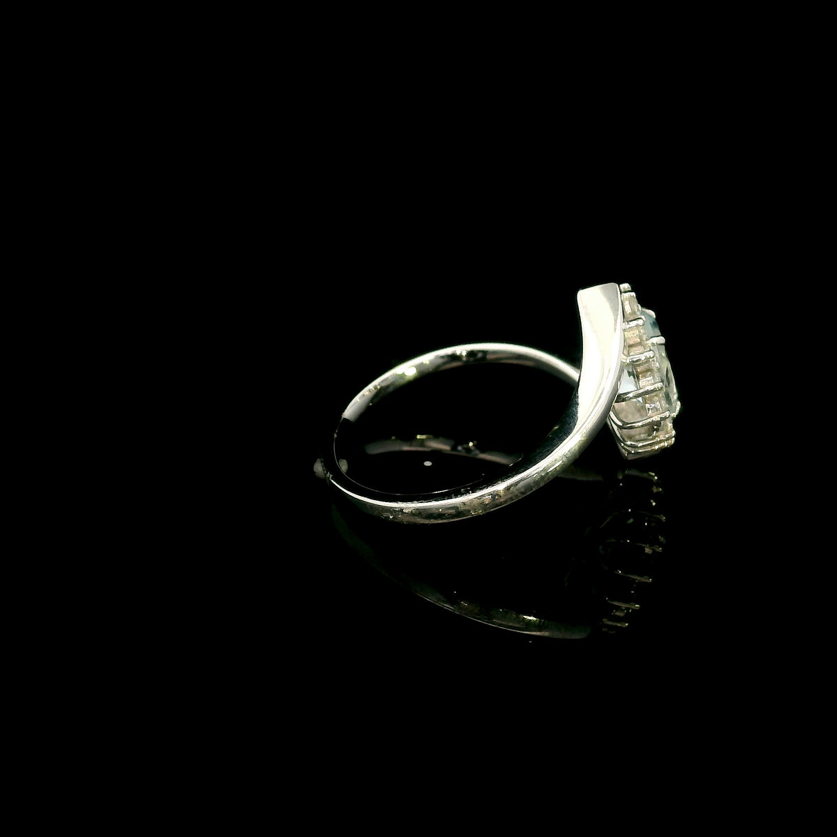 Oval aquamarine diamond halo ring with sweeping 18K white gold band