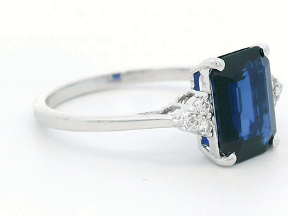 Stunning 18K Gold Emerald-Cut Sapphire Ring with Round Diamond Accents