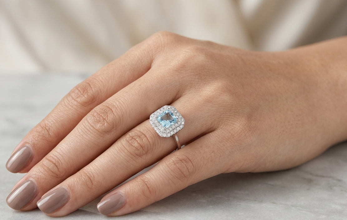 18K White Gold Asscher Cut Aquamarine Halo Ring featuring a 0.93 carat natural aquamarine surrounded by a double halo of 0.34 carat natural diamonds.