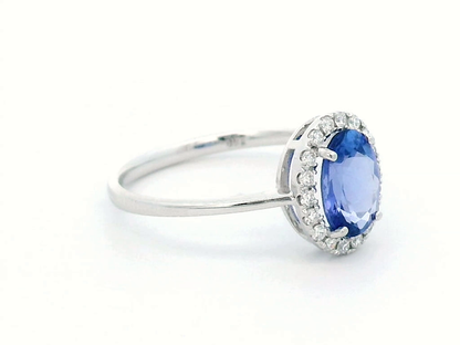 Ethereal Elegance: Oval-Cut Tanzanite and Diamond Halo Ring In 18k Gold.