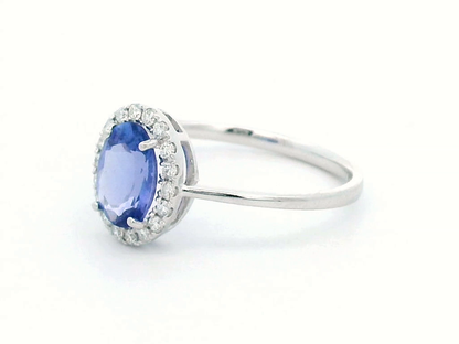 Ethereal Elegance: Oval-Cut Tanzanite and Diamond Halo Ring In 18k Gold.