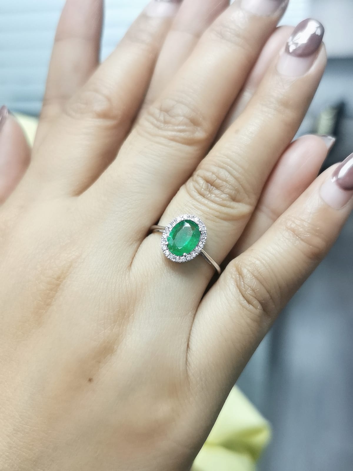 Elegant Oval Emerald and Diamond Halo Ring in 18K White Gold