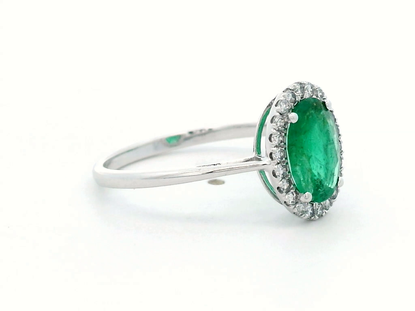 Elegant Oval Emerald and Diamond Halo Ring in 18K White Gold