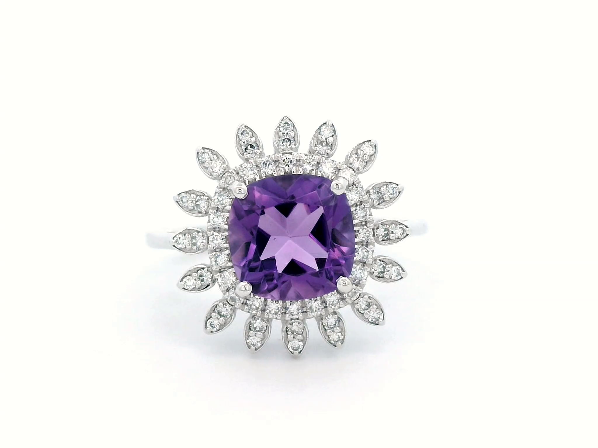 Elegant amethyst and diamond sunburst ring in 18K gold, featuring a 1.30-carat cushion-cut amethyst and 0.17-carat diamonds in a radiant halo design.