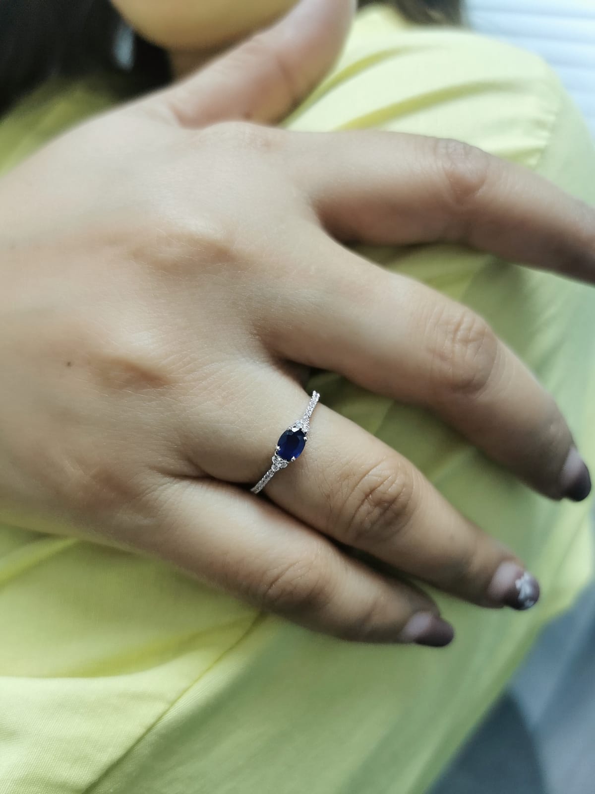 18K white gold sapphire and diamond ring featuring a 0.46-carat oval blue sapphire with 0.15 carats of sparkling diamonds on a delicate band.