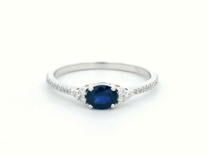 18K white gold sapphire and diamond ring featuring a 0.46-carat oval blue sapphire with 0.15 carats of sparkling diamonds on a delicate band.