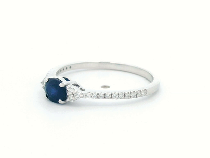 18K white gold sapphire and diamond ring featuring a 0.46-carat oval blue sapphire with 0.15 carats of sparkling diamonds on a delicate band.