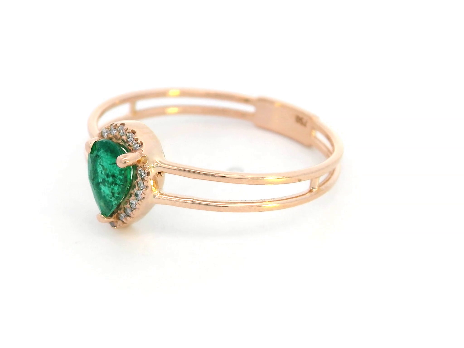 18K gold stacking-style ring with pear-cut emerald and diamond halo, featuring a split-band design for a layered look.