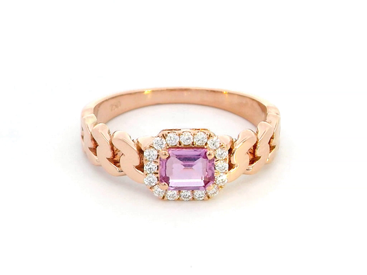 Elegant 18K gold pink sapphire and diamond halo ring with a 0.50-carat emerald-cut pink sapphire, surrounded by 0.14-carat round diamonds and a chain-link band design.