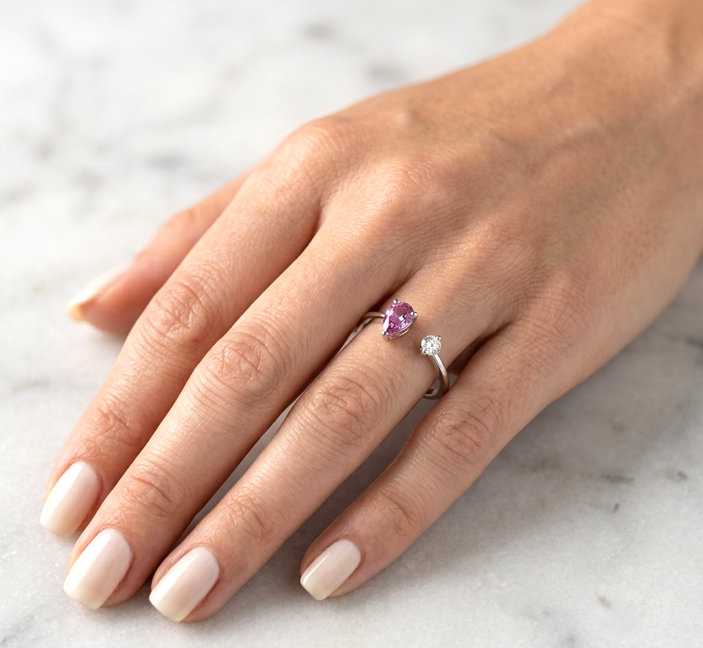 18K White Gold Open Ring featuring a 0.48 carat natural pear-shaped pink sapphire and a 0.09 carat natural round brilliant diamond in a contemporary minimalist design.