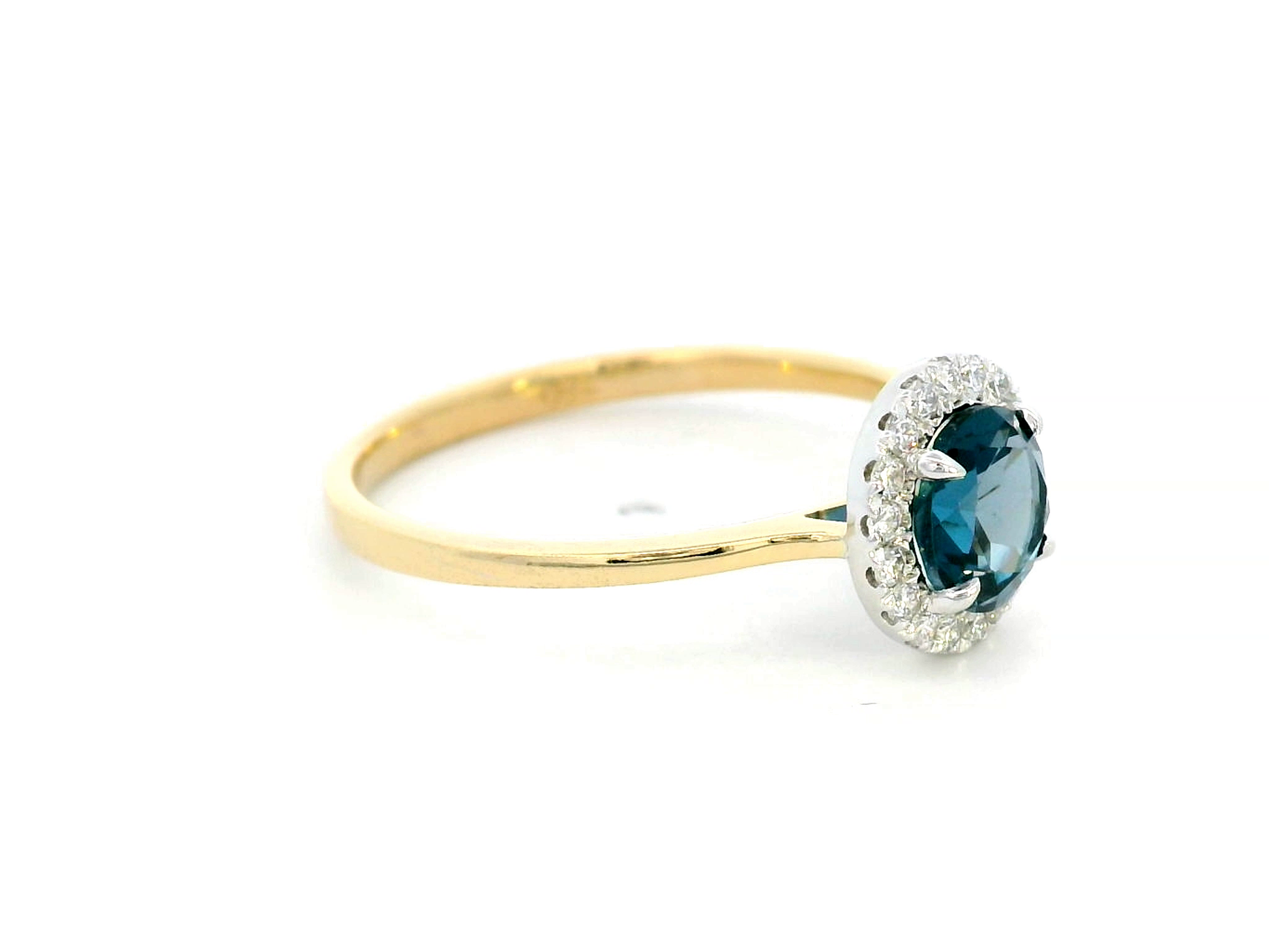 18K yellow gold ring with a 0.92-carat round-cut London blue topaz framed by a 0.15-carat diamond halo – elegant fine jewelry.