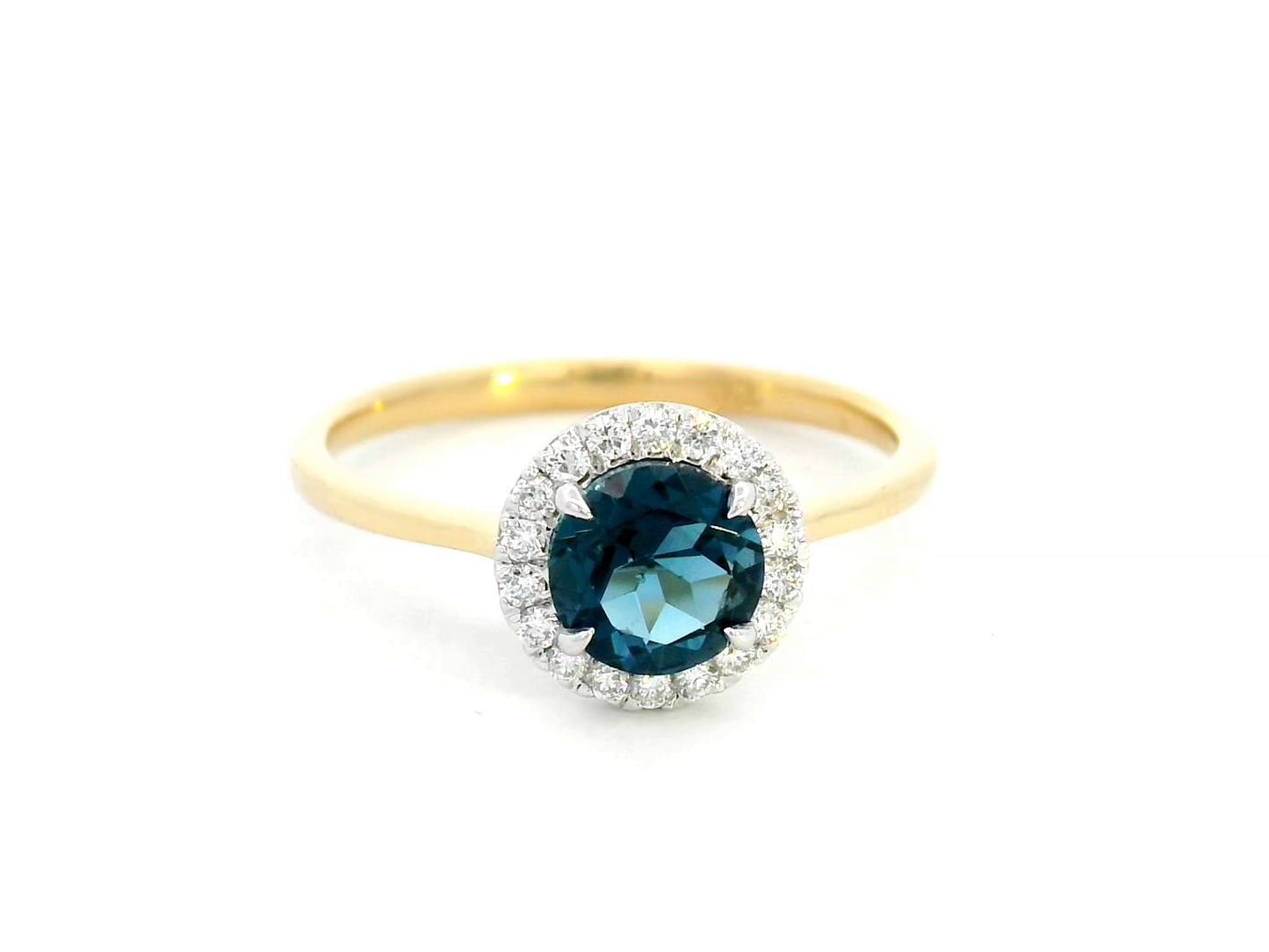 18K yellow gold ring with a 0.92-carat round-cut London blue topaz framed by a 0.15-carat diamond halo – elegant fine jewelry.