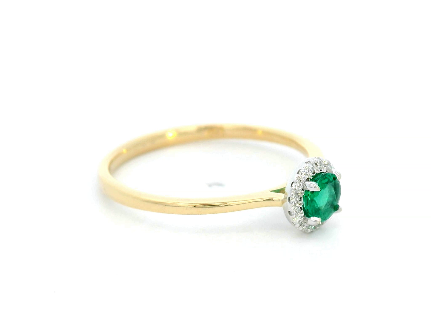 Dainty 18K gold stacking ring with a 0.25 carat emerald and 0.06 carat diamonds, perfect for fine jewelry lovers and everyday elegance.