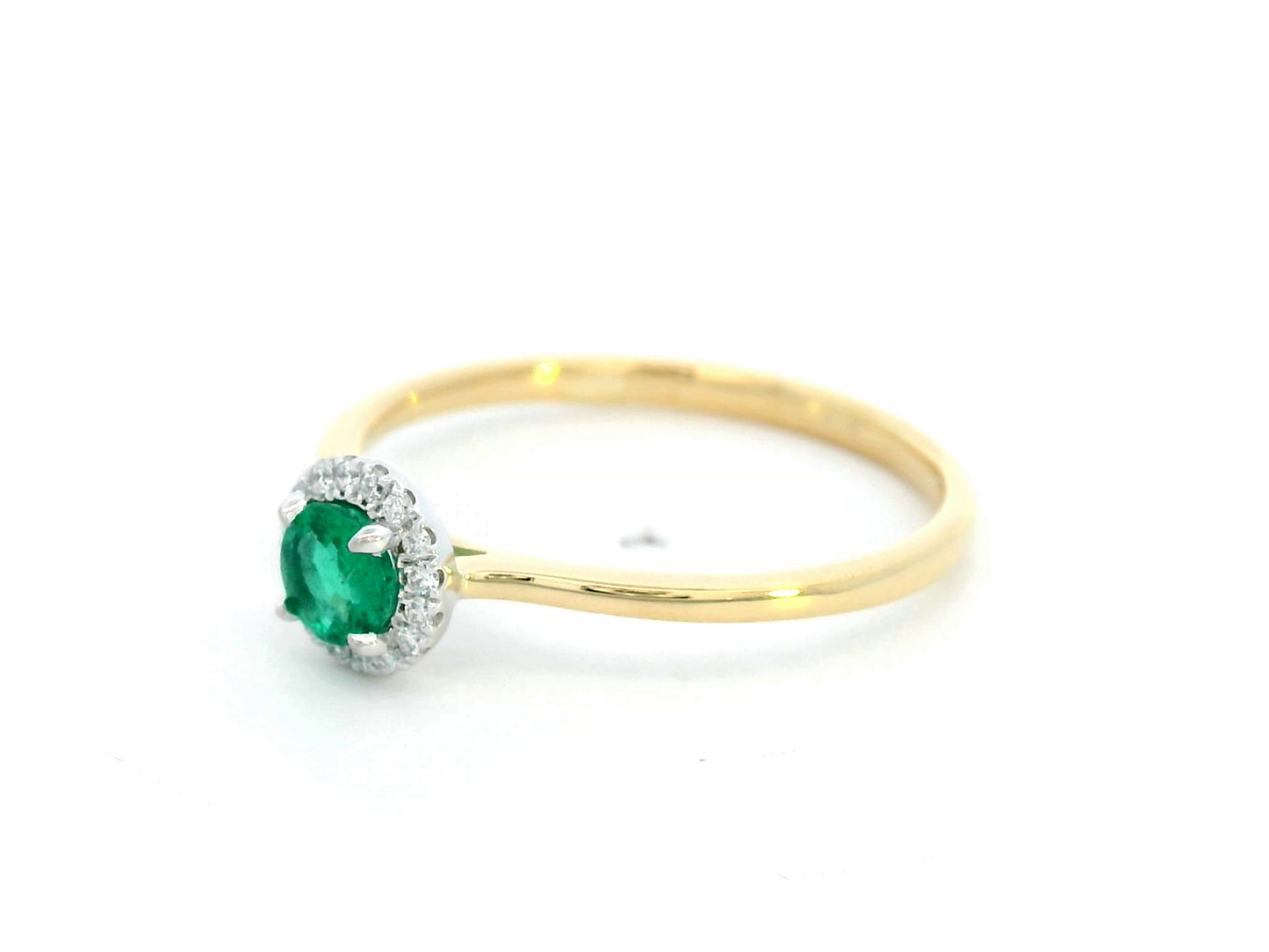 Dainty 18K gold stacking ring with a 0.25 carat emerald and 0.06 carat diamonds, perfect for fine jewelry lovers and everyday elegance.