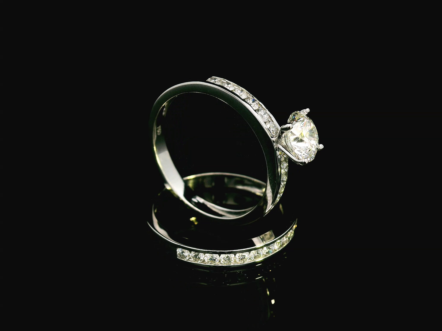 18K white gold bridal set with a 1.00-carat SI2, H-color center diamond, featuring channel-set accent diamonds totaling 0.72 carats on the engagement ring and wedding band