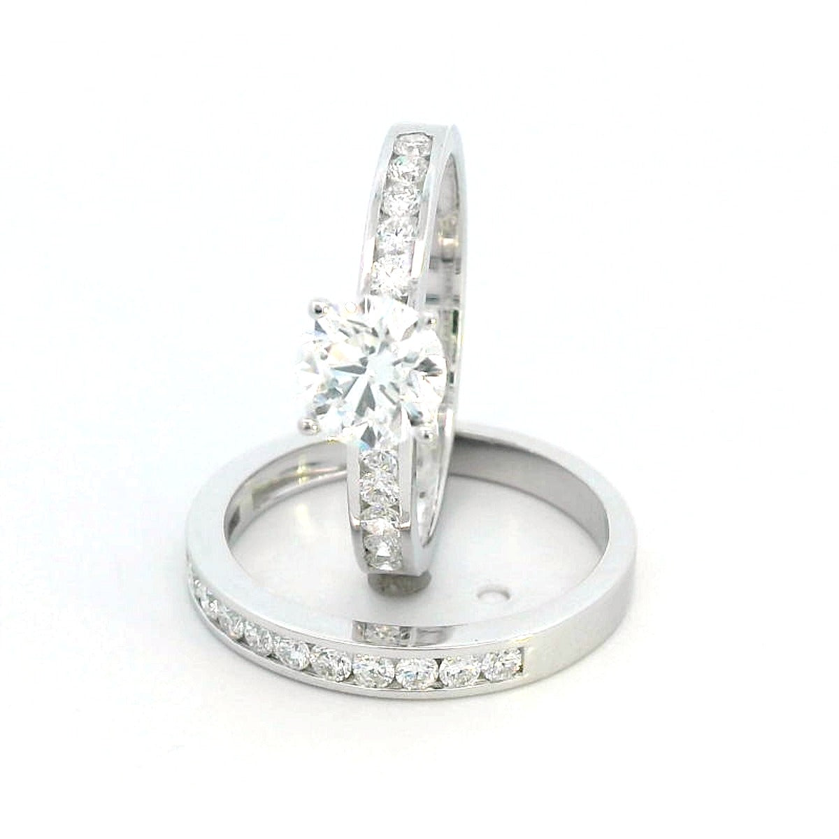 18K white gold bridal set with a 1.00-carat SI2, H-color center diamond, featuring channel-set accent diamonds totaling 0.72 carats on the engagement ring and wedding band