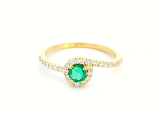 18K yellow gold halo ring featuring a 0.22-carat round emerald surrounded by 0.25-carat diamonds on a diamond-accented band.