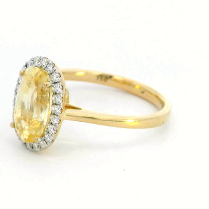 Elegant 18K Yellow Gold Ring with 3.41 Carat Oval Yellow Sapphire & Diamond Halo