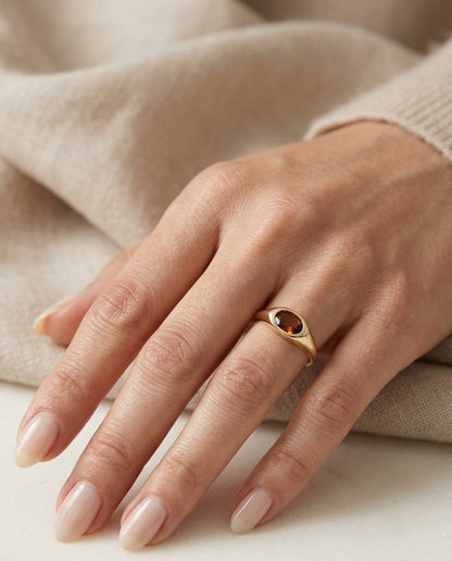 Oval citrine signet ring with east-west bezel setting in 18K yellow gold