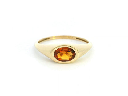 18K yellow gold ring with a 0.66-carat oval-shaped citrine in a bezel setting.