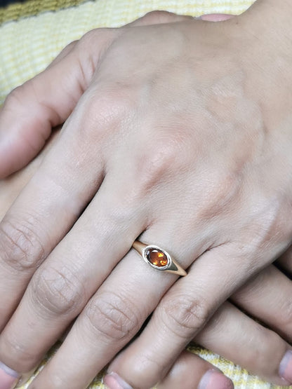 18K yellow gold ring with a 0.66-carat oval-shaped citrine in a bezel setting.