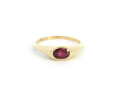 18K yellow gold ring with a 0.75-carat oval-shaped ruby in a classic bezel setting.