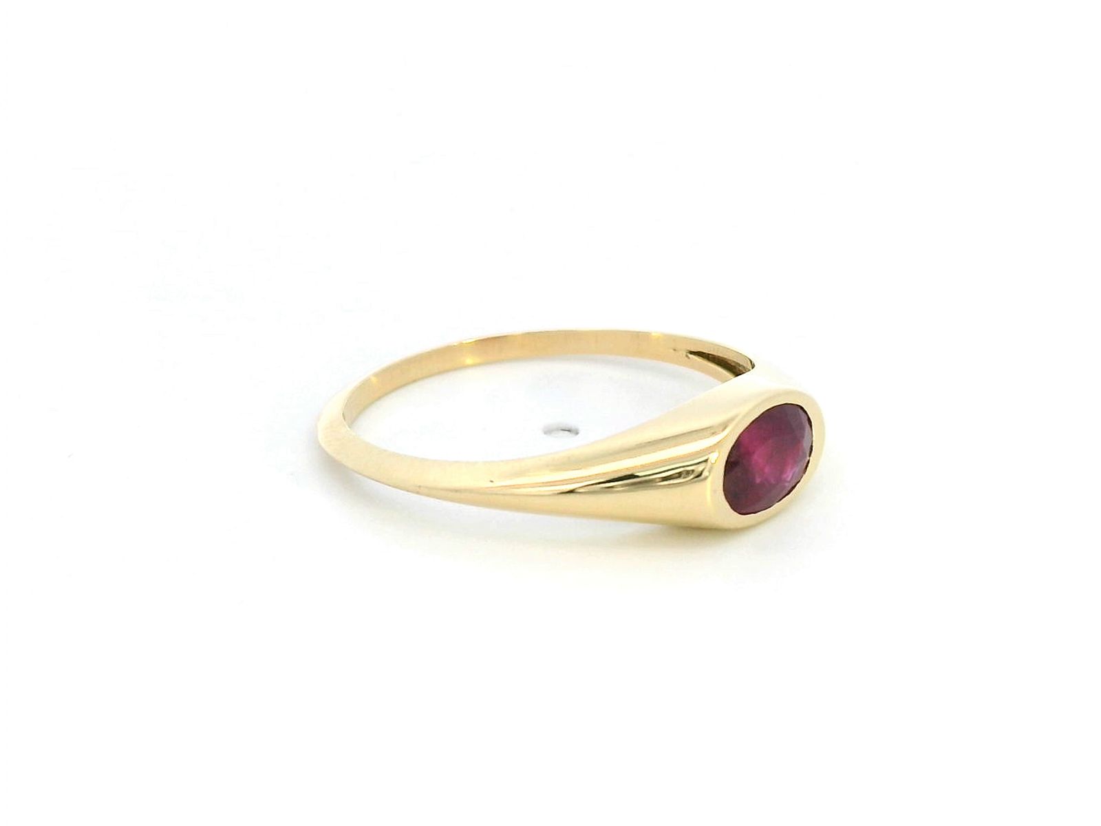 18K yellow gold ring with a 0.75-carat oval-shaped ruby in a classic bezel setting.