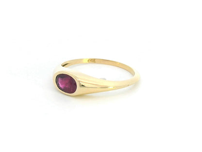 18K yellow gold ring with a 0.75-carat oval-shaped ruby in a classic bezel setting.