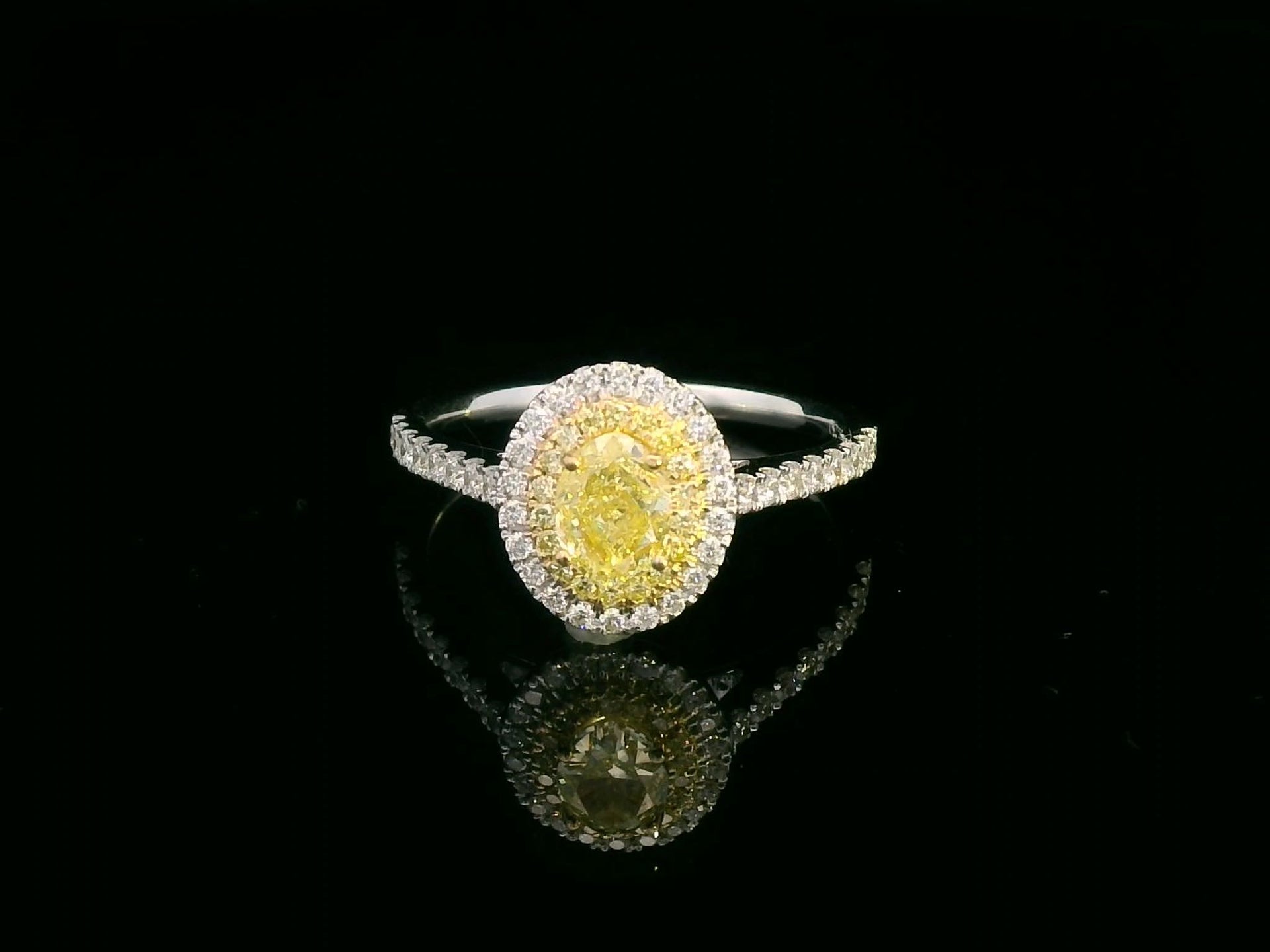 0.62 Oval-shape Fancy Yellow Diamond Halo Engagement Ring –  in 18K White Gold