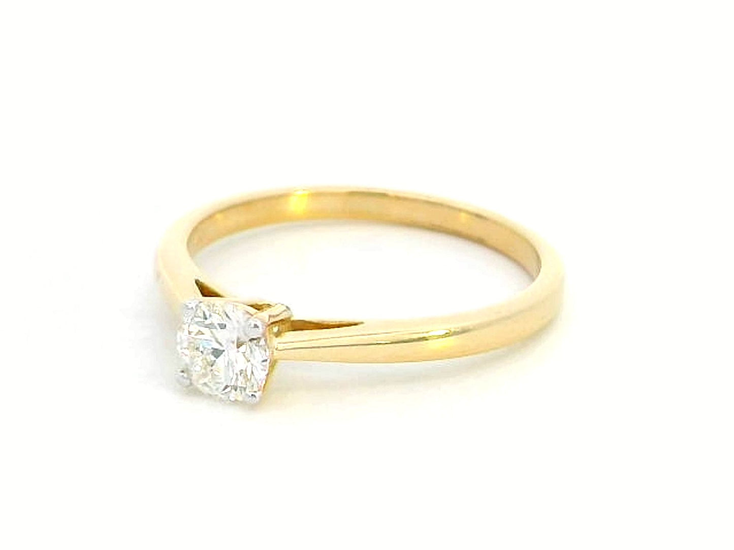 18K yellow gold solitaire ring featuring a 0.46 carat round brilliant diamond in a four-prong setting,