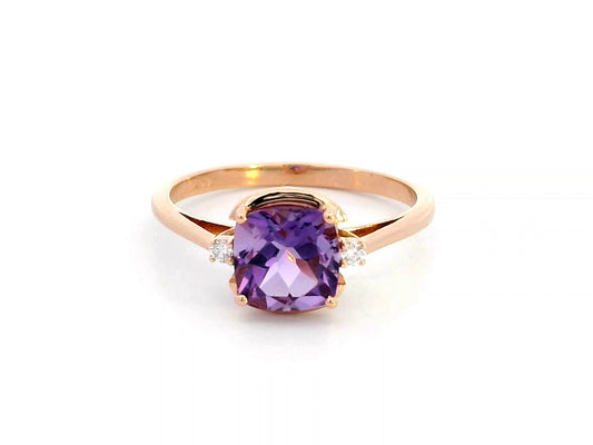 18K gold ring with a 1.51-carat cushion-cut purple amethyst center stone, accented by two round diamonds totaling 0.04 carat.