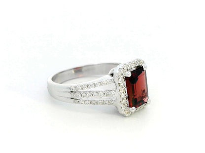 Emerald-cut 1.68-carat Garnet ring with 0.38-carat diamond halo and split-shank design in 18K gold – January birthstone engagement ring or statement jewelry.