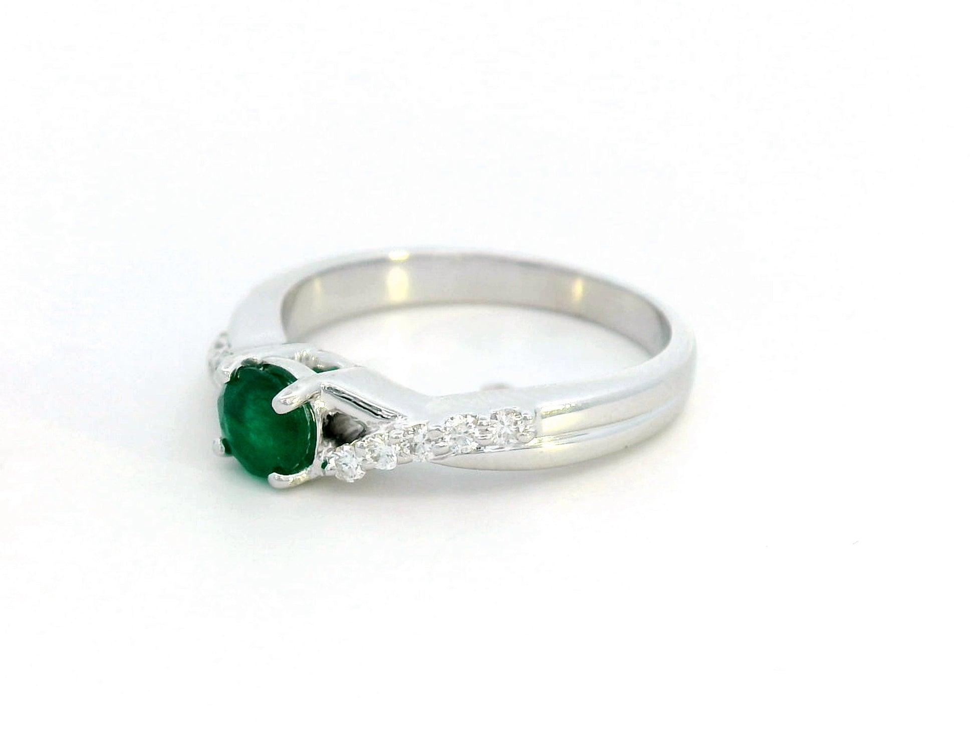 Round-cut 0.38-carat Emerald ring with 0.15-carat diamond accents in 18K gold, crossover band – May birthstone fine jewelry, engagement or cocktail ring.