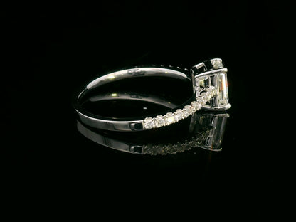 A 1.20-carat emerald-cut diamond ring set in 18K gold, featuring a diamond-studded band with 0.24 carats of round diamonds. Elegant engagement or statement jewelry.