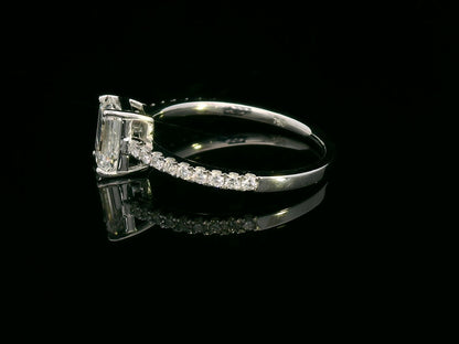 A 1.20-carat emerald-cut diamond ring set in 18K gold, featuring a diamond-studded band with 0.24 carats of round diamonds. Elegant engagement or statement jewelry.