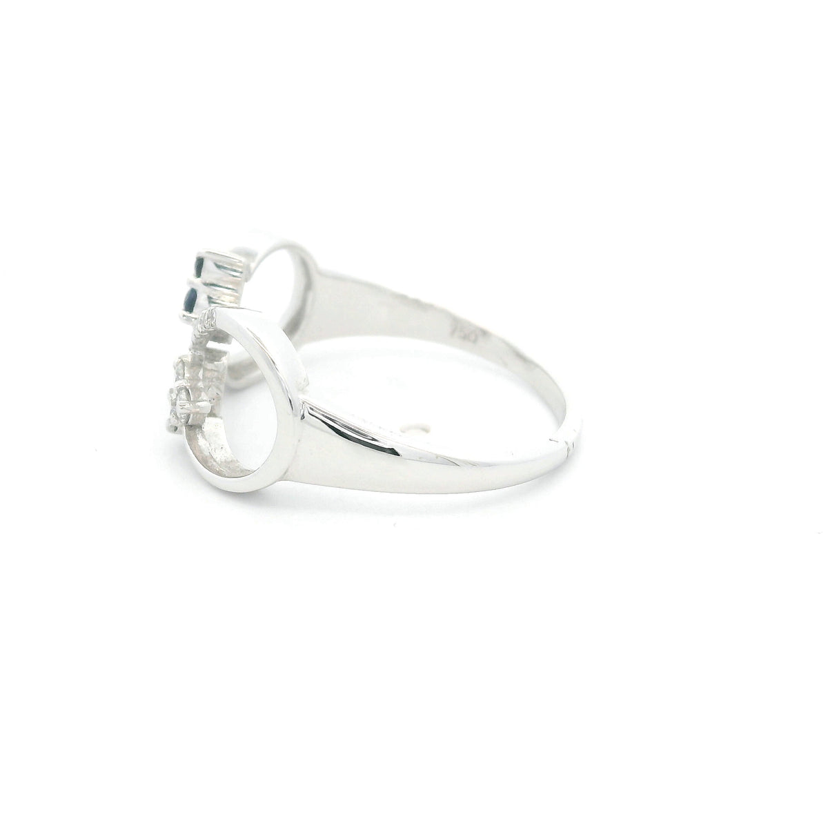 Blue sapphire and diamond infinity ring in 18K white gold with three round blue sapphires and diamond detailing.